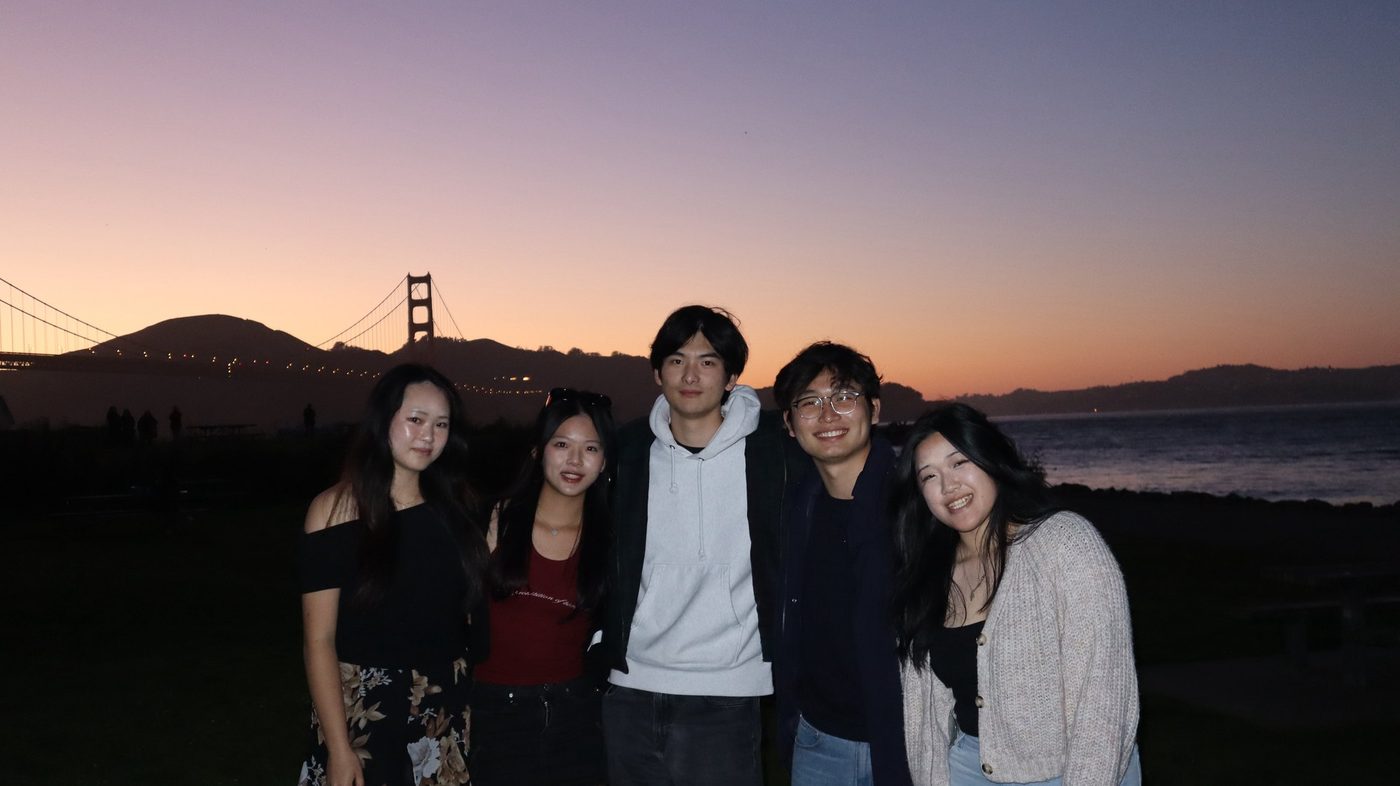 Friends at sunset with the Golden Gate Bridge behind