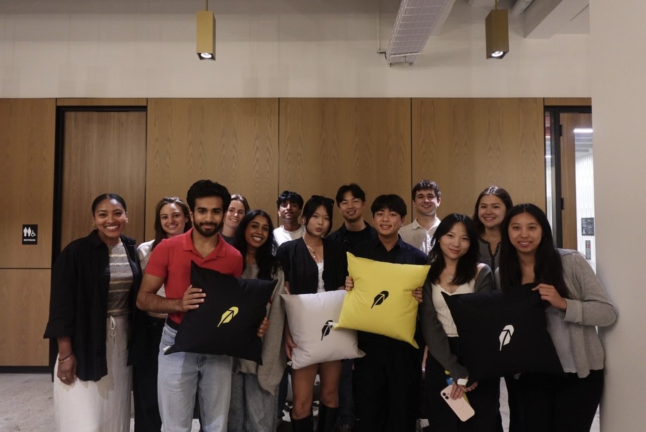 The Robinhood interns, holding Robinhood pillows